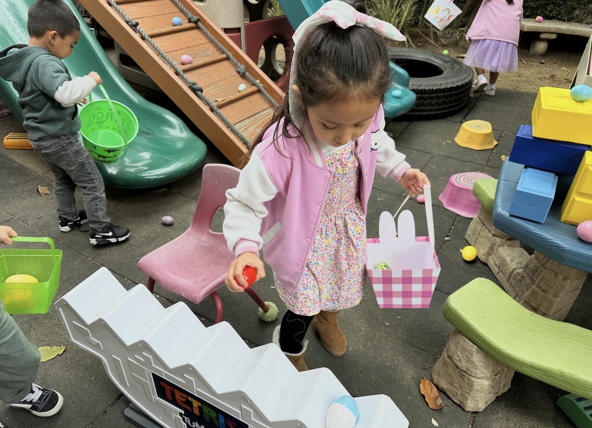 Child collecting plastic eggs in a basket during the spring egg hunt